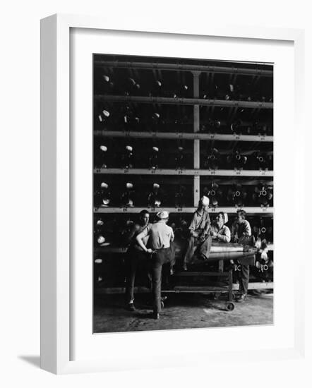 Torpedo Men Relaxing Beneath Rows of Deadly Torpedoes in Torpedo Shop During WWII-Horace Bristol-Framed Photographic Print