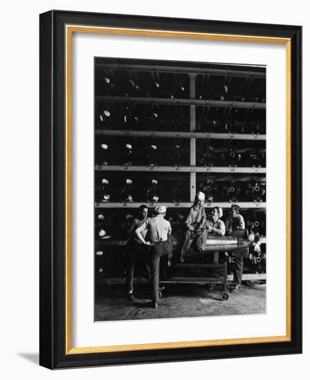 Torpedo Men Relaxing Beneath Rows of Deadly Torpedoes in Torpedo Shop During WWII-Horace Bristol-Framed Photographic Print