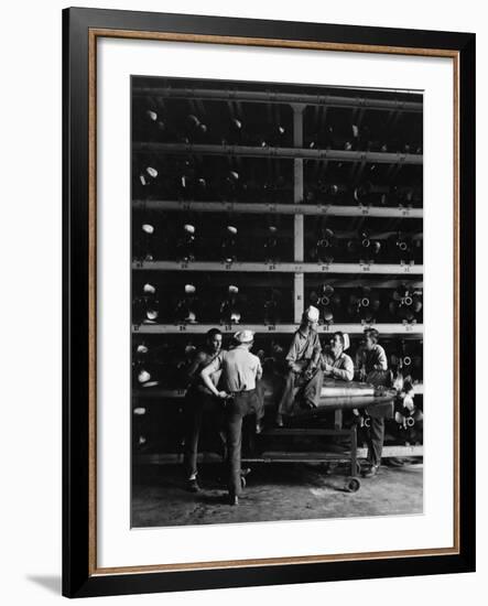 Torpedo Men Relaxing Beneath Rows of Deadly Torpedoes in Torpedo Shop During WWII-Horace Bristol-Framed Photographic Print