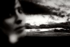 Young Woman Out of Focus in Front of Cloudy Sky Looking into the Camera-Torsten Richter-Photographic Print