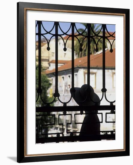 Tourist Gazes at Historic House through Iron Grillwork of Church, Lisbon, Portugal-Merrill Images-Framed Photographic Print