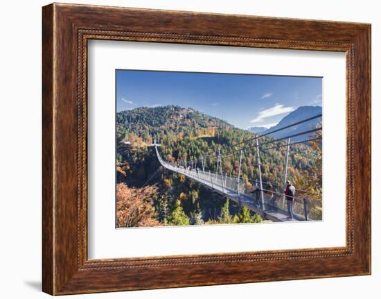 Tourists on the suspension bridge called Highline 179 framed by colorful woods in autumn, Ehrenberg-Roberto Moiola-Framed Photographic Print