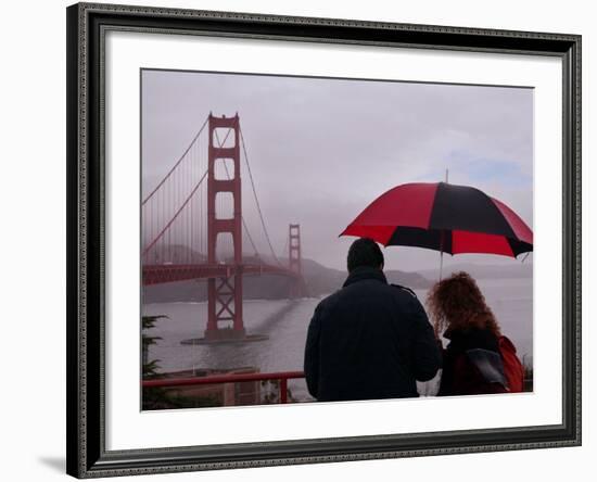 Tourists Use an Umbrella During a Light Rain, Looking at the Golden Gate Bridge in San Francisco-null-Framed Photographic Print