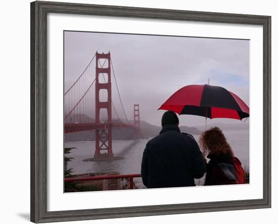 Tourists Use an Umbrella During a Light Rain, Looking at the Golden Gate Bridge in San Francisco-null-Framed Photographic Print