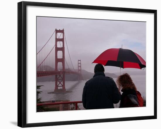 Tourists Use an Umbrella During a Light Rain, Looking at the Golden Gate Bridge in San Francisco-null-Framed Photographic Print