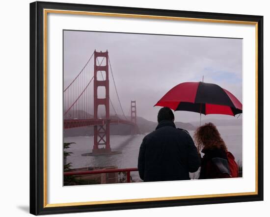 Tourists Use an Umbrella During a Light Rain, Looking at the Golden Gate Bridge in San Francisco-null-Framed Photographic Print