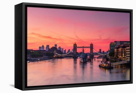 Tower Bridge, River Thames and HMS Belfast at sunrise with pink sky, and Canary Wharf-Ed Hasler-Framed Premier Image Canvas