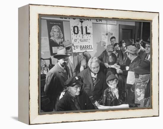 Town Residents Standing in Gas Station, Discussing Problems Caused by Oil Boom-Bernard Hoffman-Framed Premier Image Canvas