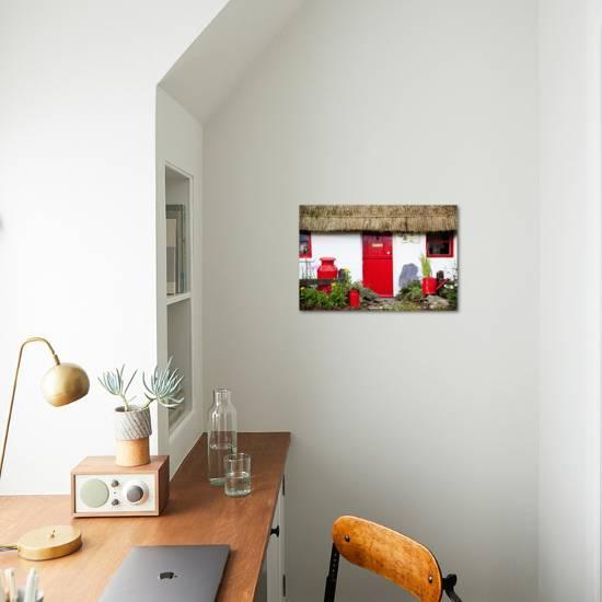 Traditional Irish Cottage With A Red Door And Red Decorative Items