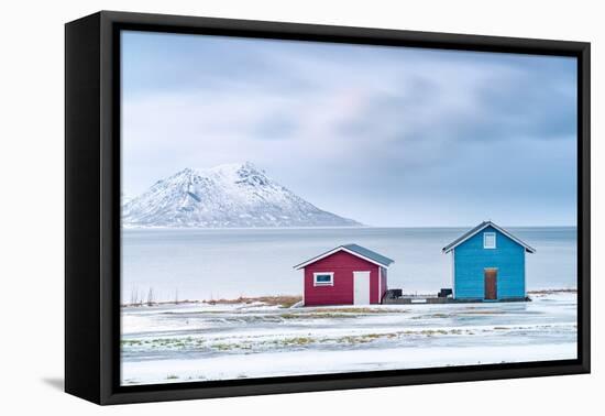 Traditional rorbu cabins overlooking the frozen sea, Troms county, Norway, Scandinavia, Europe-Roberto Moiola-Framed Premier Image Canvas