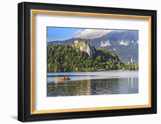 Traditional wooden pletnja rowing boat to ferry tourists to St. Mary's Church of Assumption on the-Miva Stock-Framed Photographic Print