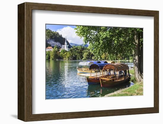 Traditional wooden pletnja rowing boat used to ferry tourists to St. Mary's Church of Assumption on-Miva Stock-Framed Photographic Print