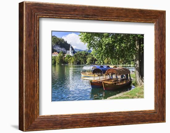 Traditional wooden pletnja rowing boat used to ferry tourists to St. Mary's Church of Assumption on-Miva Stock-Framed Photographic Print