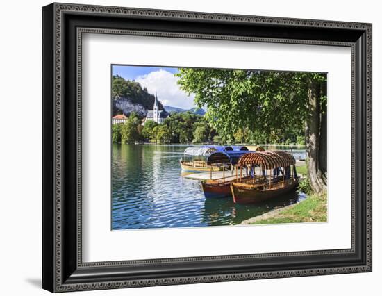 Traditional wooden pletnja rowing boat used to ferry tourists to St. Mary's Church of Assumption on-Miva Stock-Framed Photographic Print