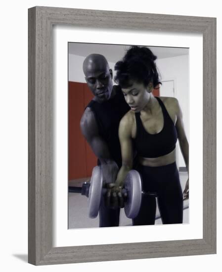 Trainer Helping Young Woman Exercise with Weights-null-Framed Photographic Print