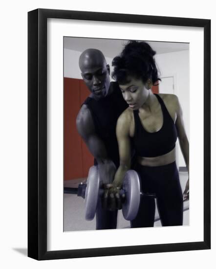 Trainer Helping Young Woman Exercise with Weights-null-Framed Photographic Print