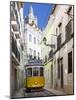 Tram (Electricos) Along Rua Das Escolas Gerais with Tower of Sao Vicente de Fora, Lisbon, Portugal-Stuart Black-Mounted Photographic Print