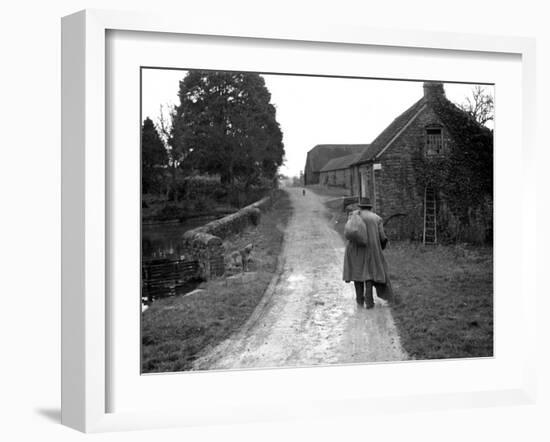 Tramp Named John Walpole Walking in Village Carrying Bag over His Shoulder-null-Framed Photographic Print