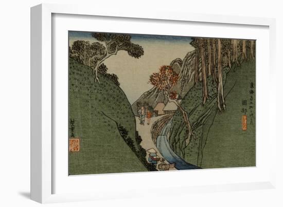 Travelers Walk Through a Narrow Passage Along a River, a Village in the Distance-Utagawa Hiroshige-Framed Art Print