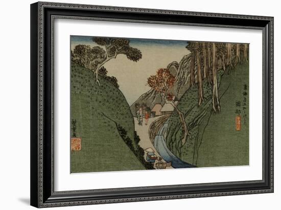 Travelers Walk Through a Narrow Passage Along a River, a Village in the Distance-Utagawa Hiroshige-Framed Art Print