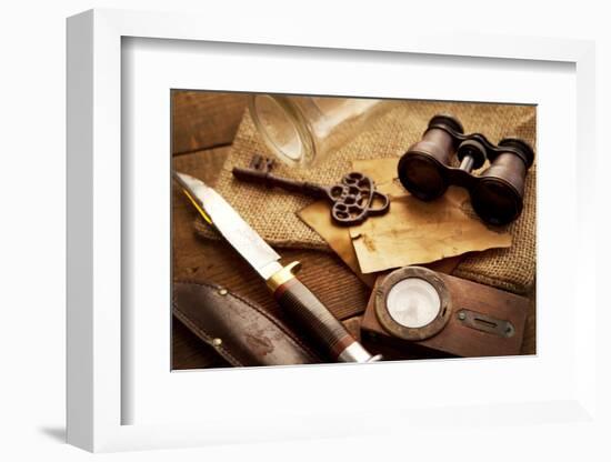 Treasure Hunting Setting, A Compass, Binoculars, Knife and a Old Key on a Old Wooden Desk-landio-Framed Photographic Print