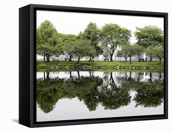 Trees are Reflected in Still Water on the Esplanade Along the Charles River in Boston-null-Framed Premier Image Canvas