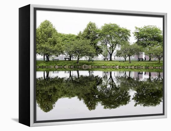 Trees are Reflected in Still Water on the Esplanade Along the Charles River in Boston-null-Framed Premier Image Canvas