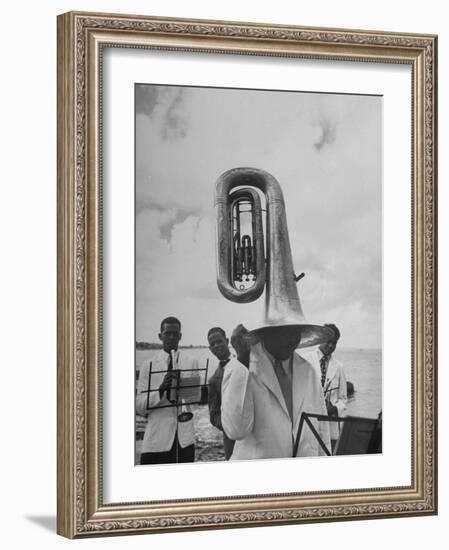 Tuba Player Keeping His Head Dry in a Rainstorm During Visit to St. Croix by Pres. Harry S. Truman-Thomas D^ Mcavoy-Framed Photographic Print