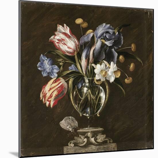 Tulips, Daffodils, Irises and Other Flowers in a Glass Vase on a Sculpted Stand, with a Butterfly-Juan de Arellano-Mounted Giclee Print