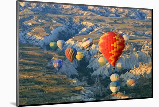 Turkey, Anatolia, Cappadocia, Goreme. Hot air balloons above Red Valley.-Emily Wilson-Mounted Photographic Print