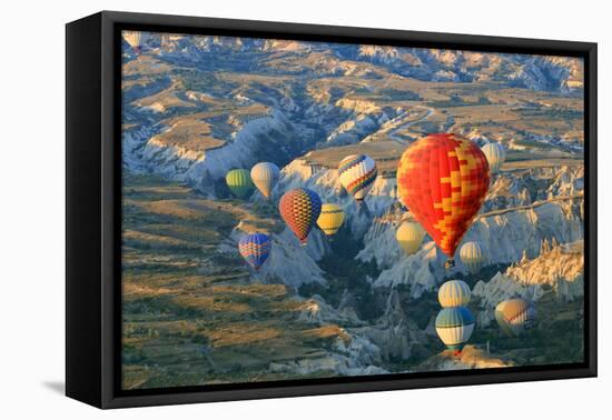 Turkey, Anatolia, Cappadocia, Goreme. Hot air balloons above Red Valley.-Emily Wilson-Framed Premier Image Canvas