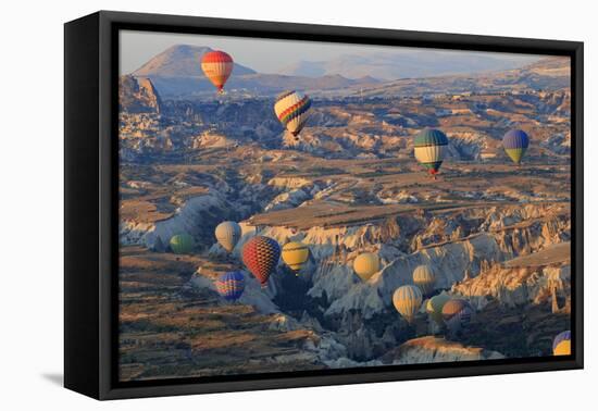 Turkey, Anatolia, Cappadocia, Goreme. Hot air balloons above Red Valley.-Emily Wilson-Framed Premier Image Canvas