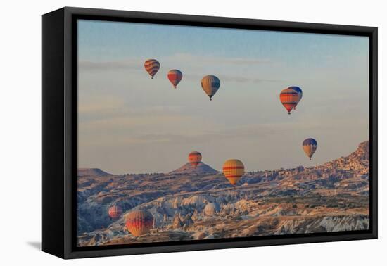 Turkey, Anatolia, Cappadocia, Goreme. Hot air balloons flying above the valley.-Emily Wilson-Framed Premier Image Canvas