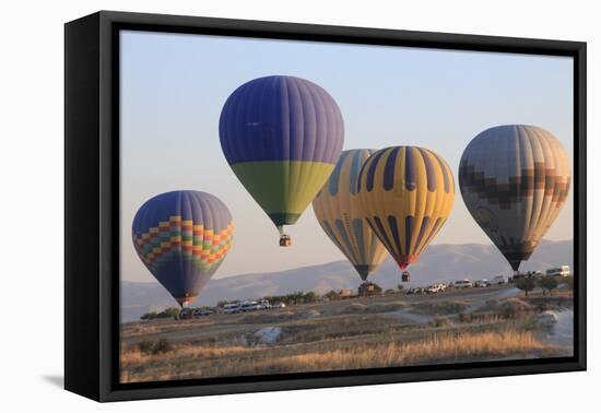 Turkey, Anatolia, Cappadocia, Goreme. Hot air balloons flying above the valley.-Emily Wilson-Framed Premier Image Canvas
