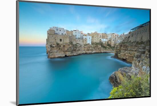 Turquoise sea at sunset framed by the old town perched on the rocks, Polignano a Mare, Province of -Roberto Moiola-Mounted Photographic Print