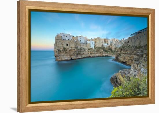 Turquoise sea at sunset framed by the old town perched on the rocks, Polignano a Mare, Province of -Roberto Moiola-Framed Premier Image Canvas