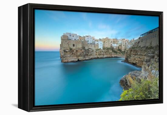 Turquoise sea at sunset framed by the old town perched on the rocks, Polignano a Mare, Province of -Roberto Moiola-Framed Premier Image Canvas