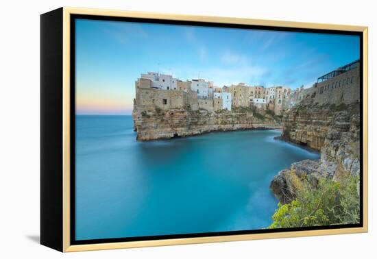 Turquoise sea at sunset framed by the old town perched on the rocks, Polignano a Mare, Province of -Roberto Moiola-Framed Premier Image Canvas
