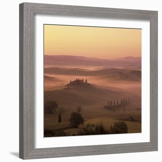 Tuscan farmhouse with cypress trees in misty landscape at sunrise, San Quirico d'Orcia-Stuart Black-Framed Photographic Print