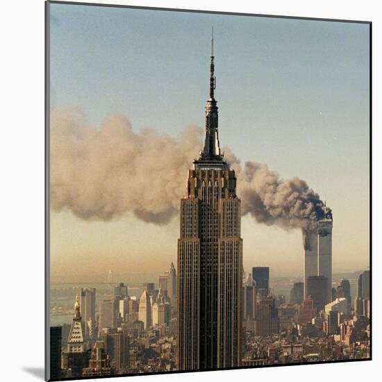 Twin Towers of the World Trade Center Burn Behind the Empire State Buildiing, September 11, 2001-null-Mounted Photographic Print