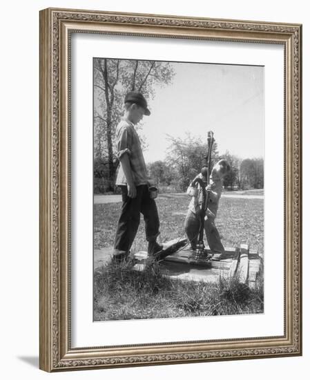 Two Boys Getting Water from a Pump at Rural School-Thomas D^ Mcavoy-Framed Photographic Print