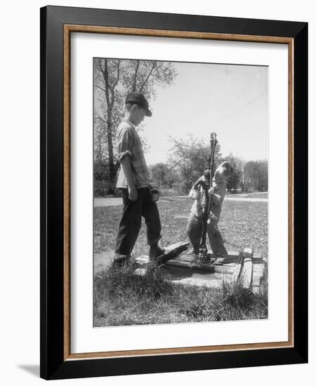 Two Boys Getting Water from a Pump at Rural School-Thomas D^ Mcavoy-Framed Photographic Print