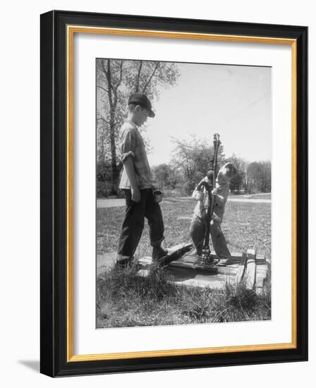 Two Boys Getting Water from a Pump at Rural School-Thomas D^ Mcavoy-Framed Photographic Print