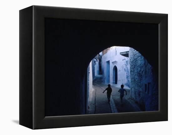 Two Boys Running Through Kasbah, Chefchaouen, Morocco-Jeffrey Becom-Framed Premier Image Canvas