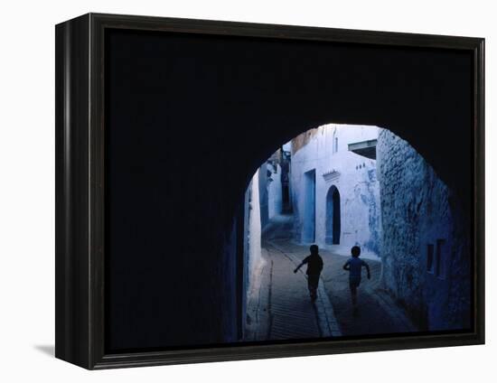 Two Boys Running Through Kasbah, Chefchaouen, Morocco-Jeffrey Becom-Framed Premier Image Canvas