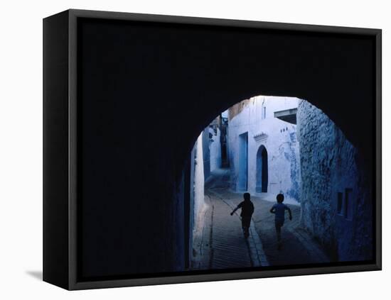 Two Boys Running Through Kasbah, Chefchaouen, Morocco-Jeffrey Becom-Framed Premier Image Canvas