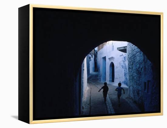 Two Boys Running Through Kasbah, Chefchaouen, Morocco-Jeffrey Becom-Framed Premier Image Canvas