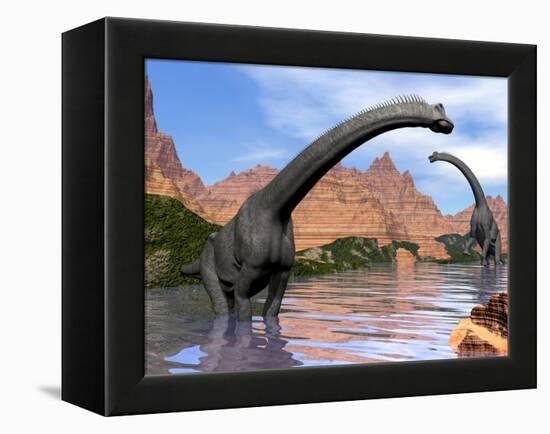 Two Brachiosaurus Dinosaurs in Water Next to Red Rock Mountains-null-Framed Stretched Canvas