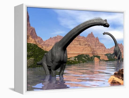 Two Brachiosaurus Dinosaurs in Water Next to Red Rock Mountains-null-Framed Stretched Canvas