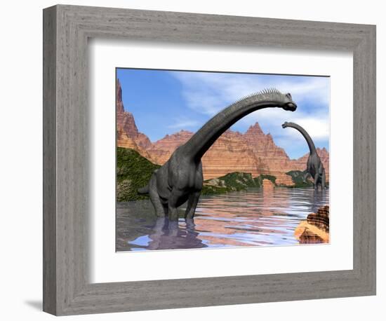 Two Brachiosaurus Dinosaurs in Water Next to Red Rock Mountains-null-Framed Premium Giclee Print